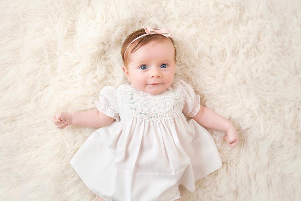 White Smocked Baby Dress with Embroidered Rosettes White Smocked Baby Dress with Embroidered Rosettes